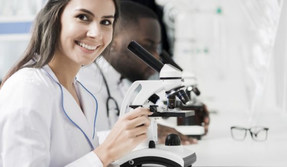 smiling-medic-with-microscope smiling-medic-with-microscope